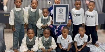 Halima Cissé poses with her nine children in Mali as the world-famous nonuplets celebrate their fifth birthday alongside a Guinness World Records certificate