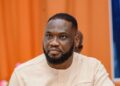 Member of Parliament Kwame Frimpong seated during an official event in Ghana