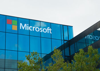 Microsoft logo displayed on the exterior of a glass office building amid delays to the company’s planned $1bn Kenya data centre project