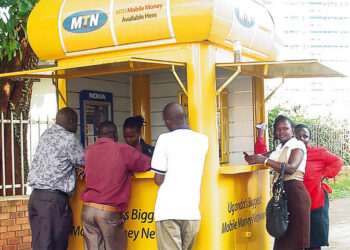 People conducting transactions at an MTN Mobile Money kiosk in Ghana amid debate over proposed digital transfer charges