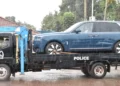 Ugandan police tow a blue Rolls-Royce Cullinan linked to parliamentary Speaker Anita Among during a corruption investigation in Kampala