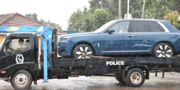 Ugandan police tow a blue Rolls-Royce Cullinan linked to parliamentary Speaker Anita Among during a corruption investigation in Kampala
