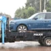 Ugandan police tow a blue Rolls-Royce Cullinan linked to parliamentary Speaker Anita Among during a corruption investigation in Kampala