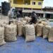 Workers sort cocoa sacks in Cote d'Ivoire amid protests over unpaid cocoa sales and growing concerns about unsold bean stocks