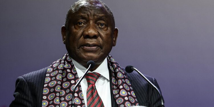 South African President Cyril Ramaphosa speaks at an international event podium during a public address on Africa and global development issues