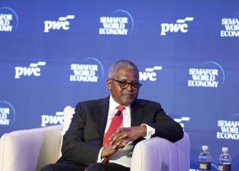 Aliko Dangote speaking on stage at the World Economy Summit in Nairobi against a Semafor and PwC-branded backdrop