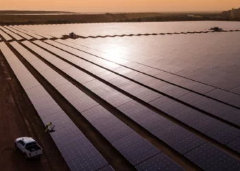 Rows of solar panels stretch across the Essakane solar power facility in Burkina Faso during sunset, highlighting the country’s growing renewable energy infrastructure