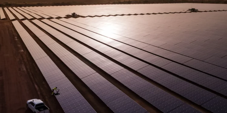 Rows of solar panels stretch across the Essakane solar power facility in Burkina Faso during sunset, highlighting the country’s growing renewable energy infrastructure