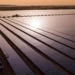 Rows of solar panels stretch across the Essakane solar power facility in Burkina Faso during sunset, highlighting the country’s growing renewable energy infrastructure