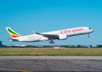 Ethiopian Airlines passenger aircraft taking off from an airport runway under clear skies in Africa