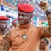Burkina Faso military leader Captain Ibrahim Traore raises his fist during a public appearance surrounded by soldiers wearing red berets