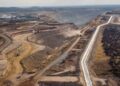 Aerial view of a large open-pit copper mining site in Namibia with haul roads, excavation areas and heavy industrial earthworks stretching across a dry landscape