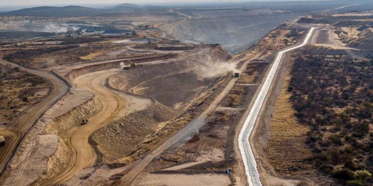 Aerial view of a large open-pit copper mining site in Namibia with haul roads, excavation areas and heavy industrial earthworks stretching across a dry landscape