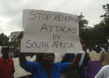 Protesters hold a placard reading ‘Stop xenophobic attacks in South Africa’ during a demonstration against anti-foreigner violence