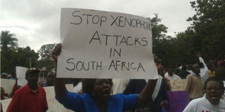 Protesters hold a placard reading ‘Stop xenophobic attacks in South Africa’ during a demonstration against anti-foreigner violence