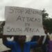 Protesters hold a placard reading ‘Stop xenophobic attacks in South Africa’ during a demonstration against anti-foreigner violence