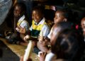 Zimbabwean schoolchildren sit together during a classroom activity, reflecting community, identity and cultural connection in Harare