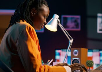 African technology professional working with AI and cloud computing infrastructure in a modern data centre