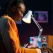 African technology professional working with AI and cloud computing infrastructure in a modern data centre