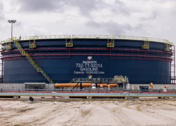 Large gasoline storage tank at the Dangote Petroleum Refinery in Lagos, Nigeria, with a capacity of 30 million litres, surrounded by pipelines and industrial infrastructure