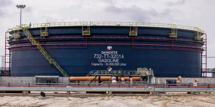 Large gasoline storage tank at the Dangote Petroleum Refinery in Lagos, Nigeria, with a capacity of 30 million litres, surrounded by pipelines and industrial infrastructure