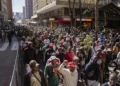 A large crowd of demonstrators marches through a city street in Johannesburg, South Africa, during a protest linked to immigration and employment concerns