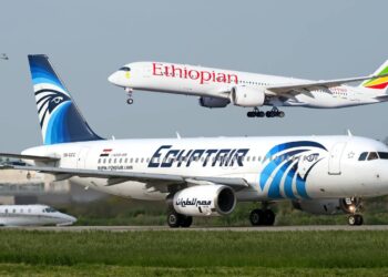An EgyptAir aircraft taxis on a runway as an Ethiopian Airlines aircraft approaches for landing, illustrating growing air connectivity and competition in Africa's aviation sector