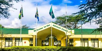 Exterior view of the African Court on Human and Peoples’ Rights in Arusha, Tanzania, with African Union member state flags displayed outside the court building