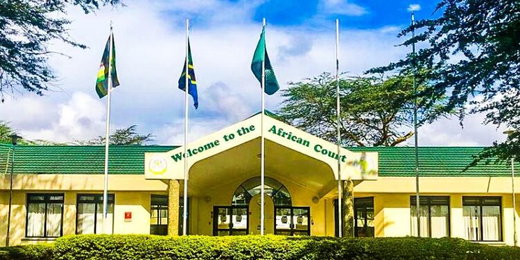 Exterior view of the African Court on Human and Peoples’ Rights in Arusha, Tanzania, with African Union member state flags displayed outside the court building
