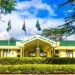 Exterior view of the African Court on Human and Peoples’ Rights in Arusha, Tanzania, with African Union member state flags displayed outside the court building