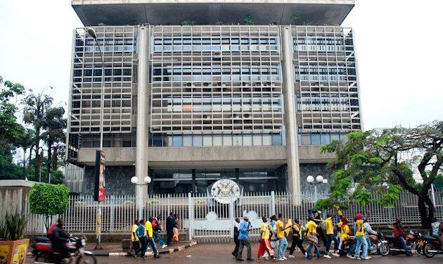 The headquarters of the Bank of Uganda in Kampala, with pedestrians walking past the central bank building amid growing efforts to promote digital payments and reduce reliance on cash transactions
