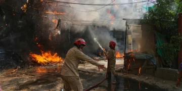 Firefighters battle a large blaze in a densely populated neighbourhood in New Delhi as flames and thick smoke engulf buildings amid a network of overhead electrical cables