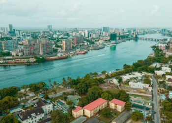 Aerial view of Lagos Island and Victoria Island waterfront showing residential neighbourhoods, commercial towers, bridges and waterways in Nigeria's economic capital