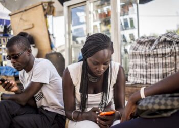 Young Africans use smartphones and mobile internet services, reflecting growing digital adoption across the continent's mobile economy