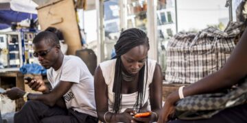Young Africans use smartphones and mobile internet services, reflecting growing digital adoption across the continent's mobile economy