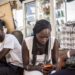 Young Africans use smartphones and mobile internet services, reflecting growing digital adoption across the continent's mobile economy