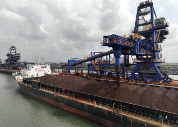 Iron ore is loaded onto a bulk carrier at Guinea's Simandou export terminal, highlighting the rapid expansion of exports from one of the world's largest new mining projects