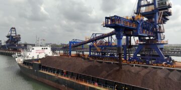 Iron ore is loaded onto a bulk carrier at Guinea's Simandou export terminal, highlighting the rapid expansion of exports from one of the world's largest new mining projects