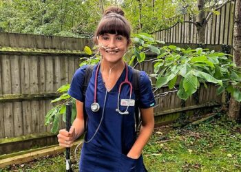 Alexandra Adams, the UK's first deafblind doctor, wearing medical scrubs during her clinical training