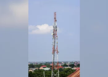 A telecommunications tower fitted with mobile network antennas in Ghana