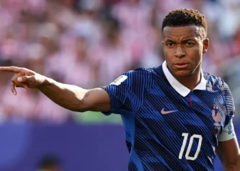 France captain Kylian Mbappe points across the pitch during a FIFA World Cup match while wearing the national team's blue jersey