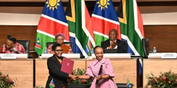 Namibian and South African officials exchange signed agreements as Presidents Netumbo Nandi-Ndaitwah and Cyril Ramaphosa look on in Pretoria