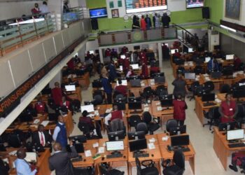 Traders monitor electronic displays on the Nigerian Exchange (NGX) in Lagos as Nigeria emerges among the world's best-performing stock markets in dollar terms following economic reforms