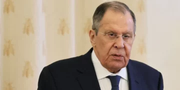 Sergey Lavrov, wearing glasses and a dark suit, speaks during a formal meeting in Moscow