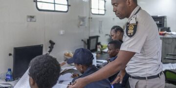 South African Home Affairs officials processing immigration documents inside a mobile office in Durban