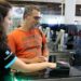 Traveller receiving assistance while scanning a passport at an automated control gate at Istanbul Airport in Turkey